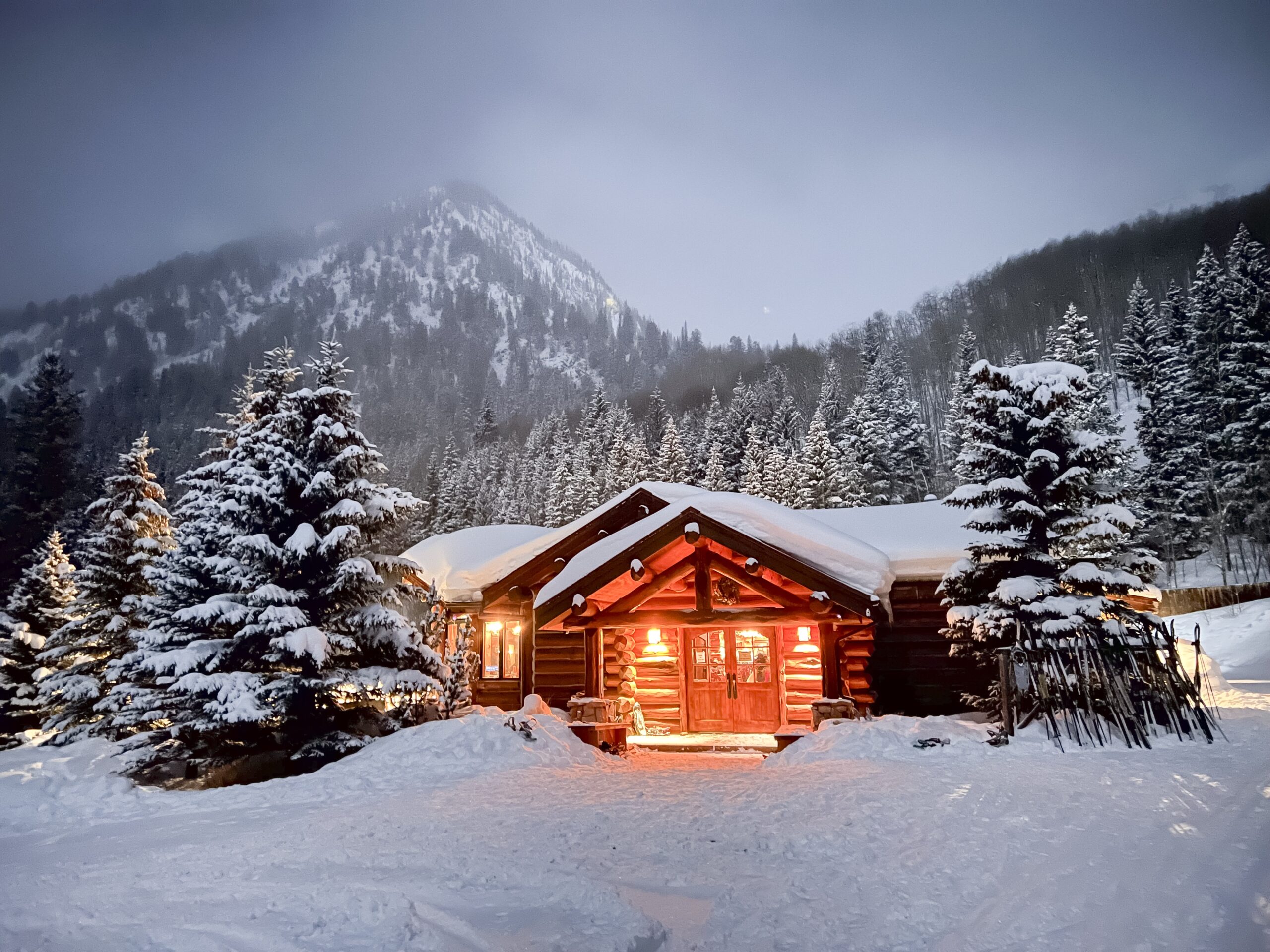 Snowy Ashcroft cabin at dusk