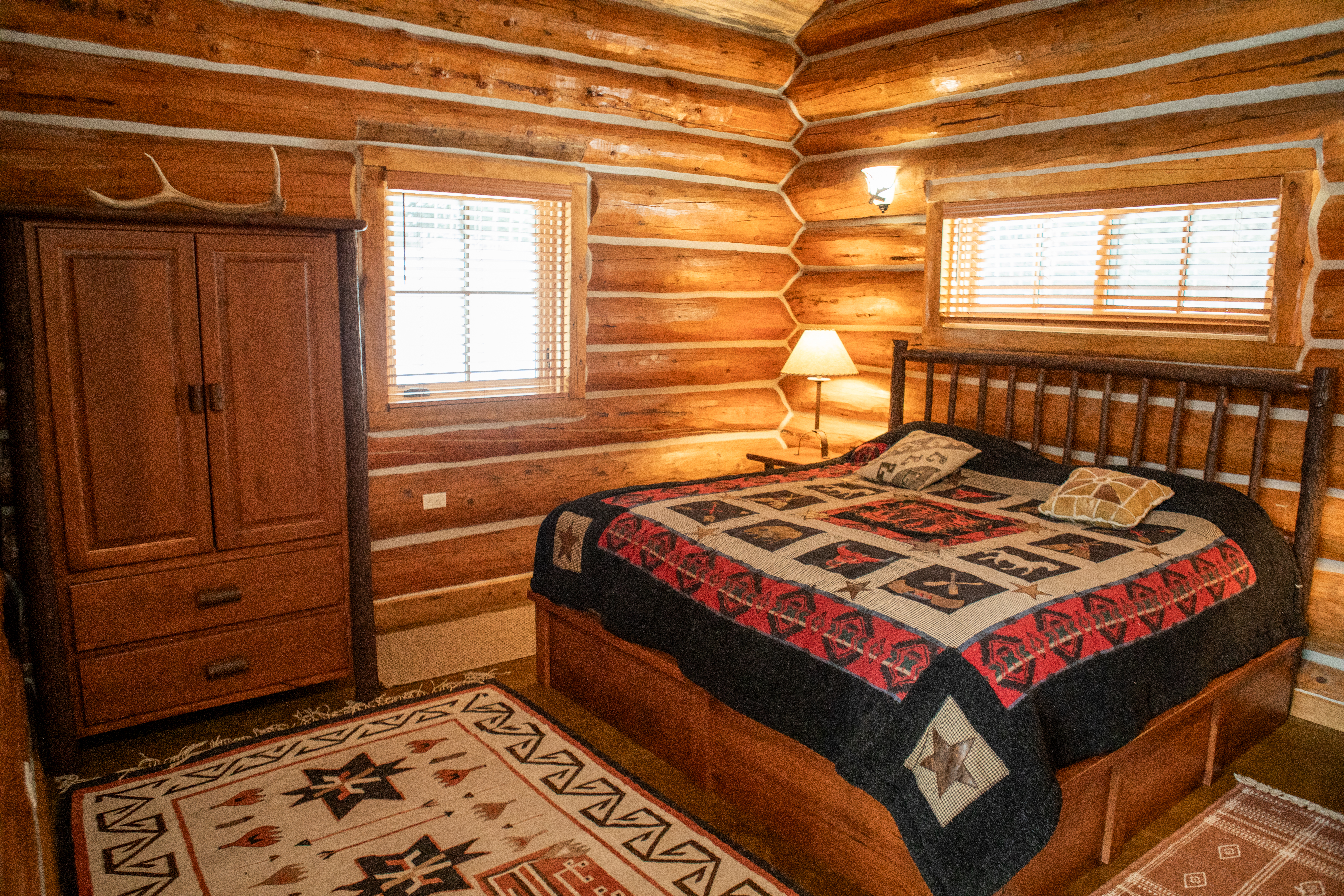Cabin bedroom with log walls