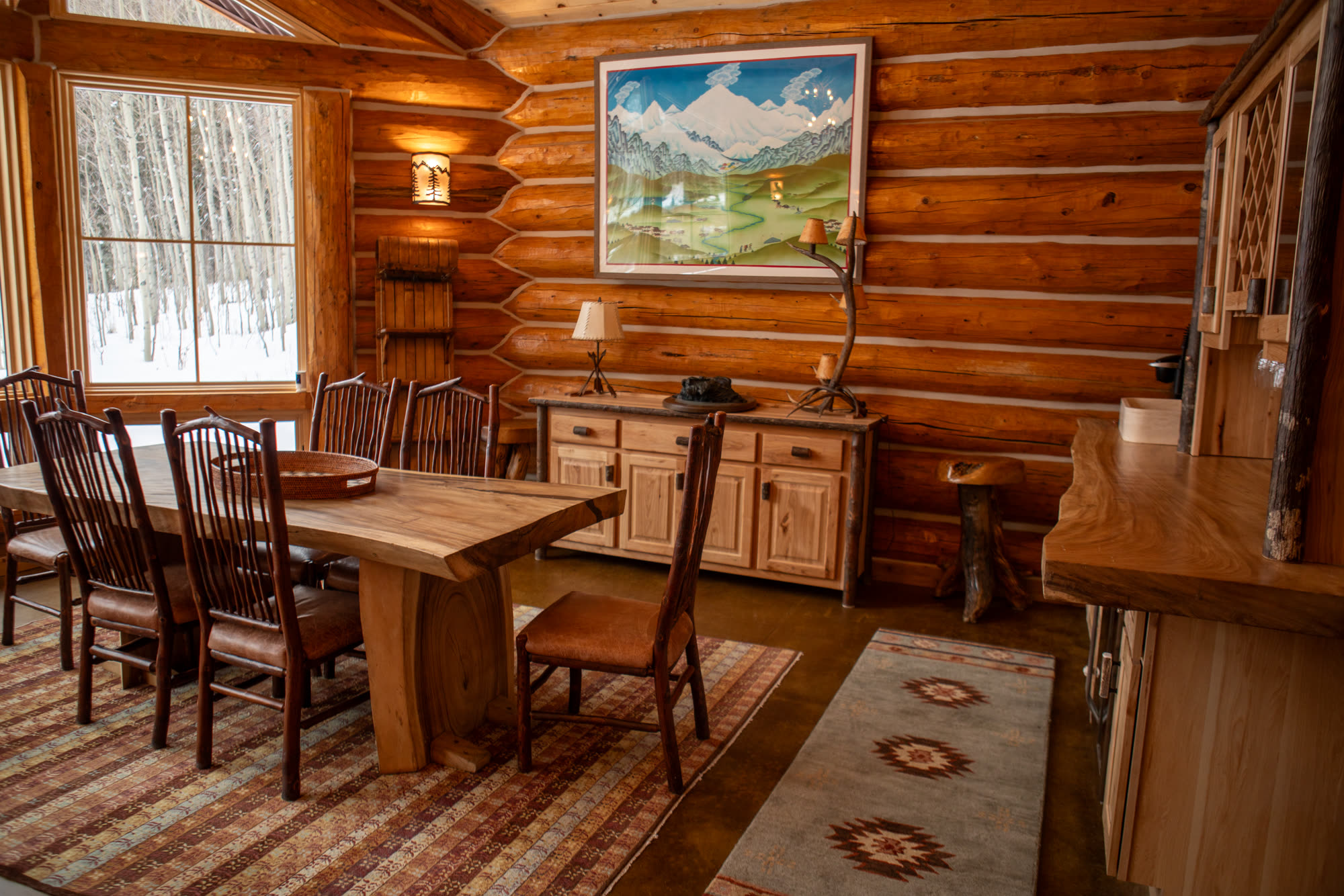 Cabin dining table with log walls