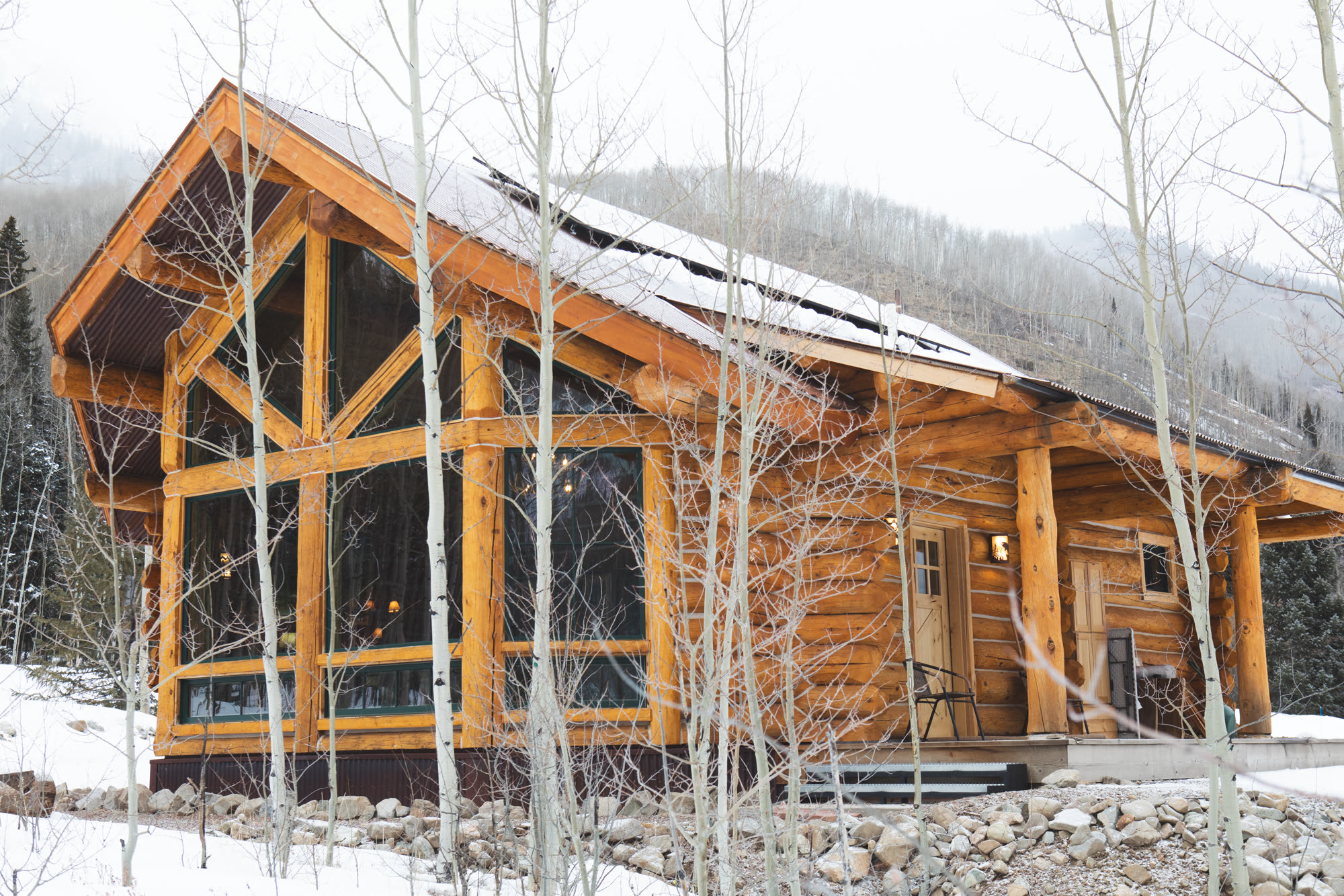 Log cabin exterior in winter aspens