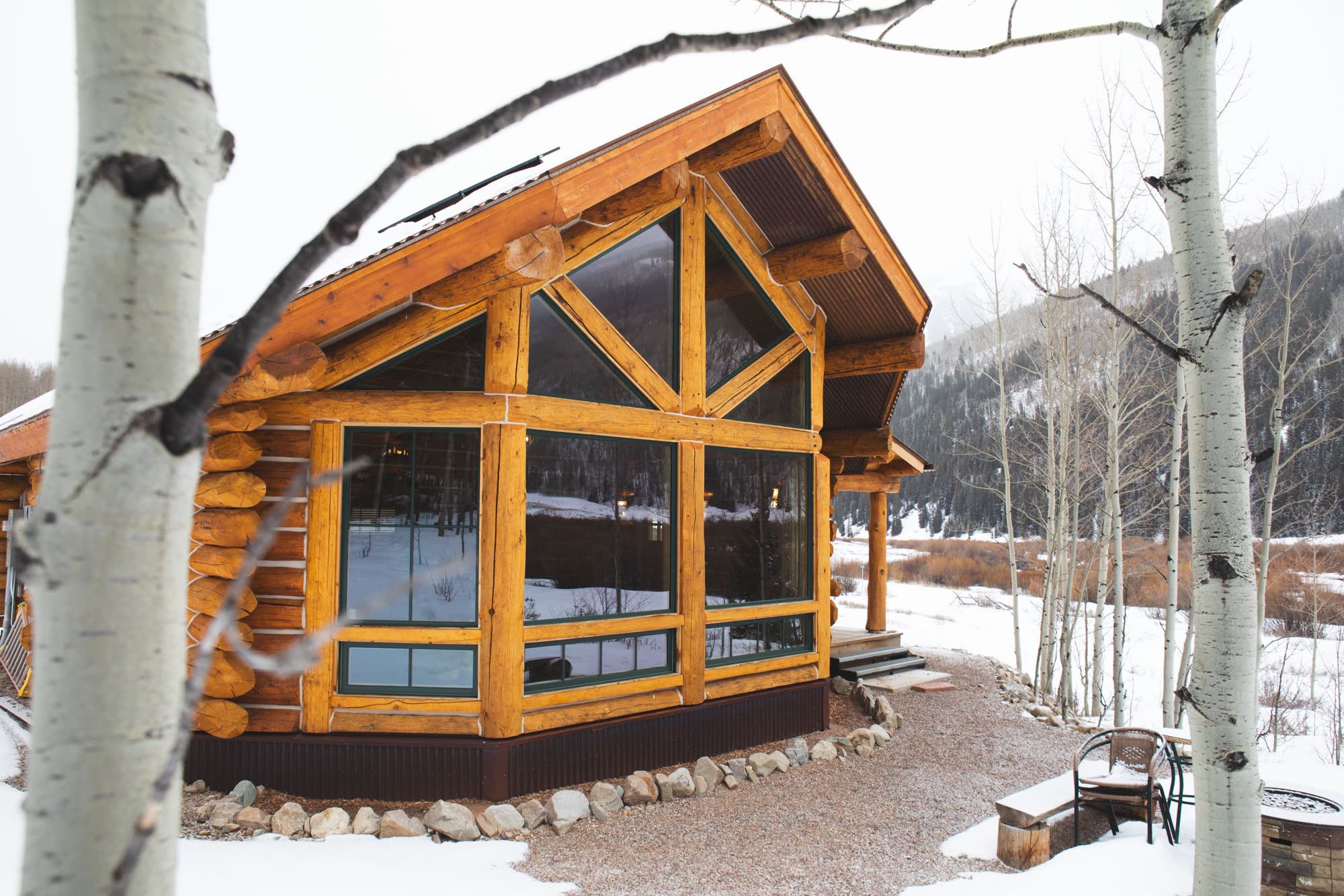 Cabin great-room windows in the snow