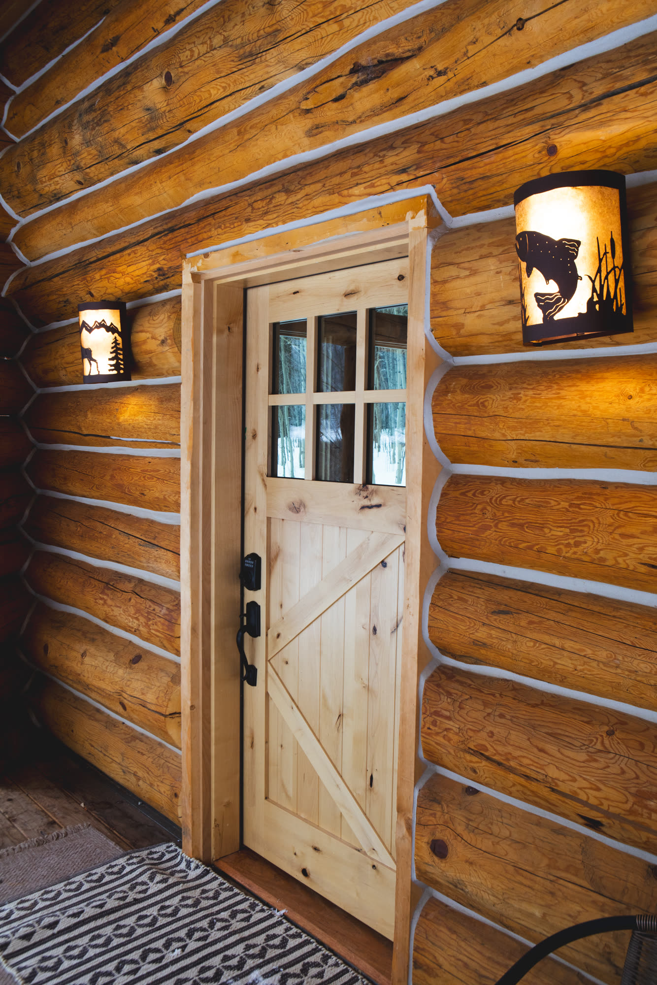 Cabin front door with lantern sconces